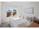 Serene bedroom featuring a large window and minimalist decor, creating a relaxing atmosphere at 2721 W 167Th Pl, Broomfield, CO 80023