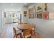 Bright dining area adjacent to the kitchen featuring light hardwood floors and a gallery wall with assorted art pieces at 2721 W 167Th Pl, Broomfield, CO 80023
