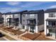 View of modern townhouses featuring balconies, solar panels, and landscaped front yards at 2721 W 167Th Pl, Broomfield, CO 80023