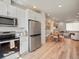 Open kitchen and dining area with stainless steel appliances and seamless flow into the living area at 2721 W 167Th Pl, Broomfield, CO 80023