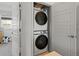 Convenient laundry area with stacked washer and dryer, and folding area at 2721 W 167Th Pl, Broomfield, CO 80023