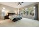 Bright bedroom featuring a large window with tree view, carpeted floor, and ceiling fan at 16113 Enchanted Peak Way, Monument, CO 80132