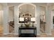 Inviting foyer with archways, hardwood floors, and a glimpse into the open-concept living spaces at 16113 Enchanted Peak Way, Monument, CO 80132