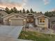 Charming single-Gathering home featuring stone accents, a well-maintained yard, and an attached two-car garage at 16113 Enchanted Peak Way, Monument, CO 80132