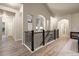 Upstairs hallway featuring hardwood floors, archways, and access to various rooms in the home at 16113 Enchanted Peak Way, Monument, CO 80132