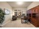 Comfortable home office with a large desk, built-in shelving, and a relaxing armchair at 16113 Enchanted Peak Way, Monument, CO 80132