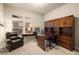Inviting home office with natural light, a wooden desk, built-in shelving, and comfortable seating at 16113 Enchanted Peak Way, Monument, CO 80132