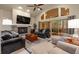 Bright living room with fireplace, vaulted ceilings, and sliding glass doors to a private patio at 16113 Enchanted Peak Way, Monument, CO 80132