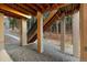 Covered patio with exposed beams and stone pillars, seamlessly blending indoor and outdoor spaces at 16113 Enchanted Peak Way, Monument, CO 80132