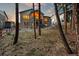 Rear exterior showcasing a spacious yard, a covered patio, and scenic woodland views at 16113 Enchanted Peak Way, Monument, CO 80132