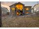 This home's rear exterior has a covered patio and stairs leading to a gravel yard at 16113 Enchanted Peak Way, Monument, CO 80132