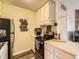 Kitchen features white cabinets, black stove and stainless steel appliances at 3100 S Federal Blvd # 321, Denver, CO 80236