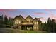 Back of the beautiful home with a large deck perfect for entertaining and enjoying scenic views at 30041 Marys Dr, Conifer, CO 80433