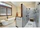 Luxurious bathroom featuring a soaking tub, a large shower, and natural light from a window at 30041 Marys Dr, Conifer, CO 80433