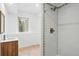 Bathroom featuring tiled shower, mosaic accents, and a wood vanity at 30041 Marys Dr, Conifer, CO 80433