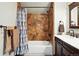 Bathroom with a tub/shower combo and a sink vanity with a dark wood finish at 30041 Marys Dr, Conifer, CO 80433