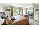 Bright bedroom with two windows, neutral carpet and walls, and space for a desk at 30041 Marys Dr, Conifer, CO 80433