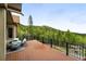 Wood deck with metal railing and picturesque mountain views at 30041 Marys Dr, Conifer, CO 80433