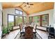 Elegant dining room with hardwood floors, large windows with great views, and wood plank ceiling at 30041 Marys Dr, Conifer, CO 80433