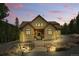 Inviting front view of the home with manicured landscaping and stone pathway with beautiful pink sky at 30041 Marys Dr, Conifer, CO 80433