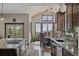 Open-concept kitchen with stainless appliances, granite countertops, and views of the beautiful scenery at 30041 Marys Dr, Conifer, CO 80433