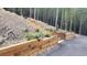 Beautiful terraced landscaping with stone stairs, retaining walls, and colorful flowers at 30041 Marys Dr, Conifer, CO 80433