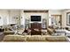 Comfortable living room featuring hardwood floors, a decorative rug, and built-in shelving on either side of the TV at 30041 Marys Dr, Conifer, CO 80433