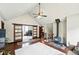 Open concept living room featuring a wood burning stove and sliding doors to an office at 30041 Marys Dr, Conifer, CO 80433