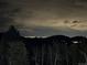 Scenic night view of distant city lights from a mountain vantage point at 30041 Marys Dr, Conifer, CO 80433