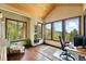 Bright office with tongue and groove ceiling, hardwood floors, lots of windows and forest views at 30041 Marys Dr, Conifer, CO 80433