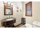 Stylish powder room featuring a unique sink vanity, tile floor, and a window at 30041 Marys Dr, Conifer, CO 80433
