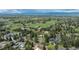 Sweeping aerial view of the property showcasing the lush green neighborhood and mountain views in the distance at 4285 S Hudson Pkwy, Englewood, CO 80113