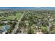Expansive aerial view of the neighborhood showcasing lush greenery, nearby streets, and mountain views on the horizon at 4285 S Hudson Pkwy, Englewood, CO 80113