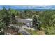Overhead view of the home, showcasing the surrounding mature trees and mountain views in the background at 4285 S Hudson Pkwy, Englewood, CO 80113