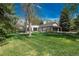 Spacious backyard showcasing mature trees, an expansive lawn, and a patio area ideal for outdoor gatherings at 4285 S Hudson Pkwy, Englewood, CO 80113