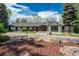 Stunning home with mature trees, circular driveway, and beautifully landscaped front yard, all under a bright blue sky at 4285 S Hudson Pkwy, Englewood, CO 80113
