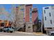 Modern building with exterior stairs, gray and red finish, and a visible address at 3040 Zuni St # F, Denver, CO 80211