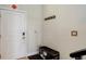 Bright entryway with a white door, coat hooks, a bench, and easy access at 3040 Zuni St # F, Denver, CO 80211