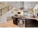Open-concept kitchen featuring stainless steel appliances, dark cabinetry and granite countertops at 3040 Zuni St # F, Denver, CO 80211