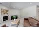 Comfortable and spacious living room featuring a fireplace, grand piano, and ample seating at 3040 Zuni St # F, Denver, CO 80211