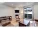 Bright living room features a fireplace, sliding glass doors, comfortable seating, and lots of natural light at 3040 Zuni St # F, Denver, CO 80211