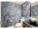 Cozy powder room featuring floral wallpaper, a modern sink, and a sleek toilet at 3040 Zuni St # F, Denver, CO 80211