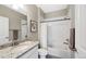Bathroom with granite countertops, a single sink, a bathtub with shower, and fresh white tiles at 4500 Copeland Cir # 104, Highlands Ranch, CO 80126