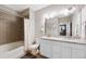 Bright bathroom featuring double vanity with granite countertops and tiled shower with tub at 4500 Copeland Cir # 104, Highlands Ranch, CO 80126