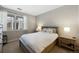 Bedroom with a large window offering ample natural light, complemented by a comfortable bed and side tables at 4500 Copeland Cir # 104, Highlands Ranch, CO 80126