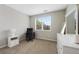 Bright bedroom with a large window, desk and chair, dresser, and neutral-toned carpet at 4500 Copeland Cir # 104, Highlands Ranch, CO 80126