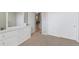 Spacious bedroom with ample storage, including a dresser and multiple closets with white doors at 4500 Copeland Cir # 104, Highlands Ranch, CO 80126