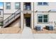 Inviting condo entrance with a black door and a convenient staircase at 4500 Copeland Cir # 104, Highlands Ranch, CO 80126