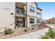 Townhouse exterior with a patio area, grill, landscaping, and visible address number at 4500 Copeland Cir # 104, Highlands Ranch, CO 80126