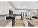 Beautiful kitchen featuring granite counters, stainless appliances, and white cabinetry at 4500 Copeland Cir # 104, Highlands Ranch, CO 80126